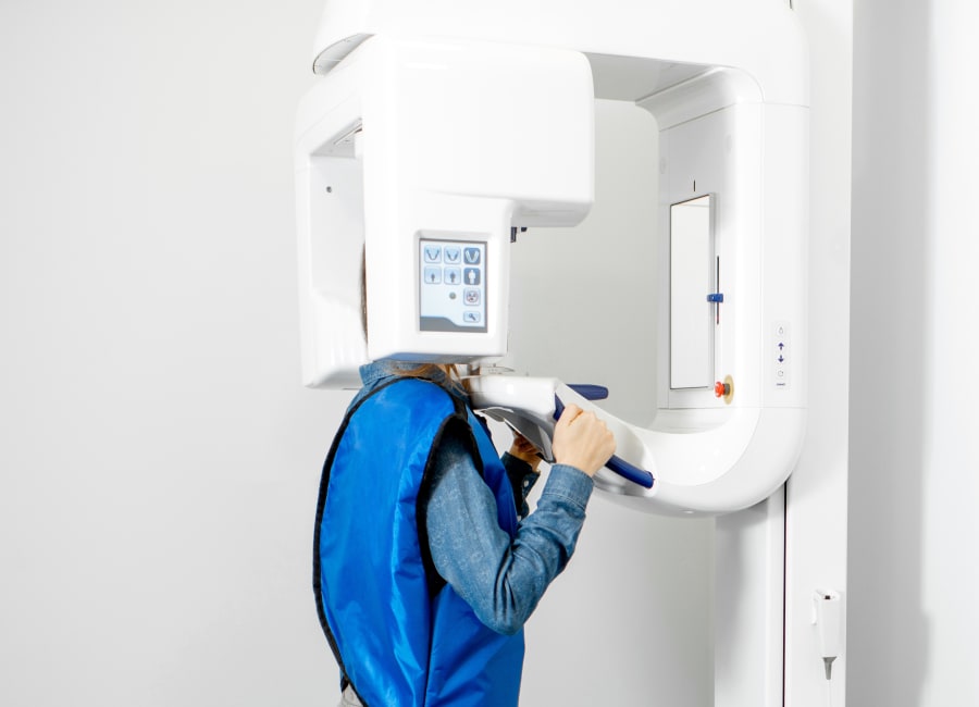 A dentist points to a panoramic X-ray.